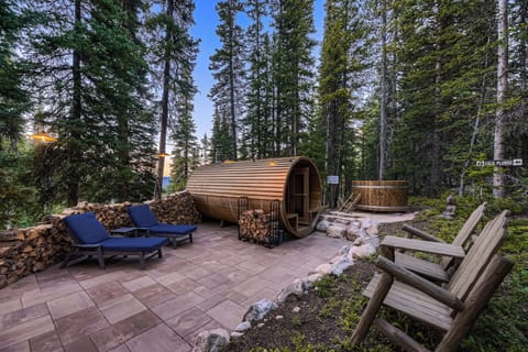 Relaxation patio w/ barrel sauna, chaise chairs and cold plunge.  