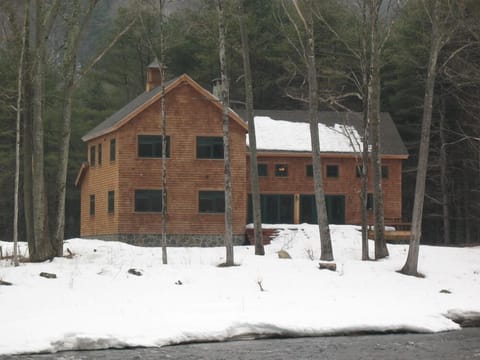 Picture of the back of the house shows just how close the river is.
