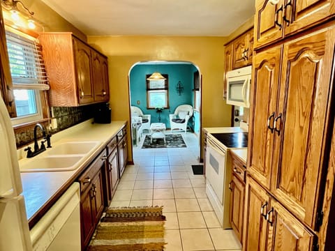 Kitchen leading into the sunny sunroom!