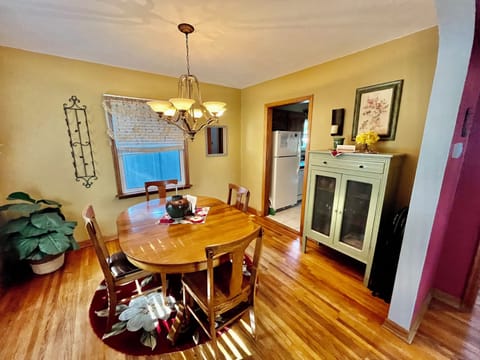Dining room with adjustable table able to seat up to 9.