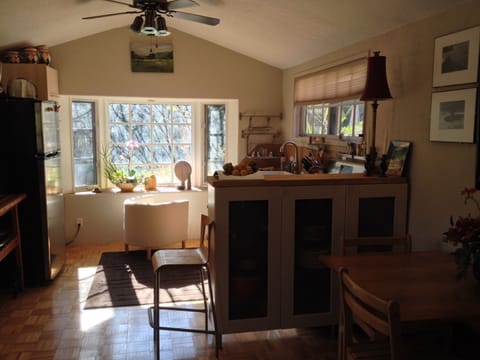dining area with china cabinet dividing kitchen area with bay window