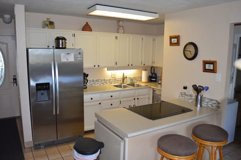 Fully equipped kitchen with bar seating.