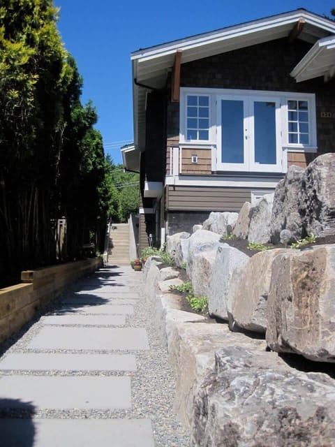 Front of home looking at pathway to suite.  Suite is on the right at the flower pot.
