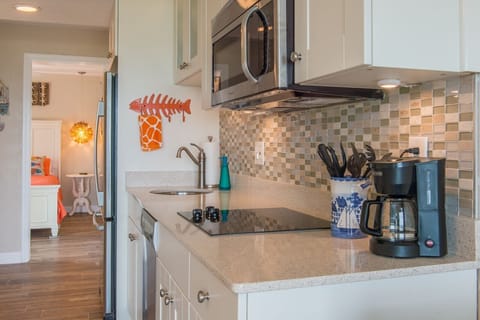 Kitchen, quartz counter top, stainless appliances, flat top, and convection oven.