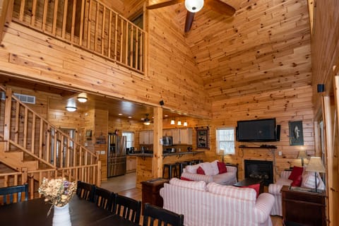 Great Room has comfy seating, 19ft ceiling, gas fireplace, 75" TV.