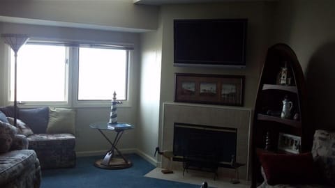 Living room with fireplace and windows looking over the lake