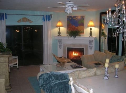Living Room Opens to Balcony and features local artwork and large Tv and sofabed
