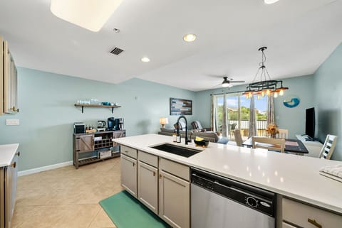 Fully stocked kitchen equipped with cookware, dishes, glassware, utensils