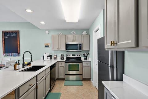 Kitchen includes Refrigerator with ice maker, Stove, Microwave, and Dishwasher 