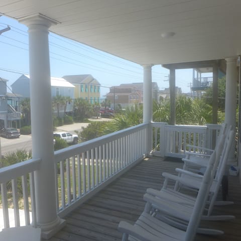 Front porch with rocking chairs and view of the Atlantic