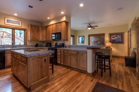 Eat in or dine out! Kitchen adjacent to sitting area with 5 bar stools!
