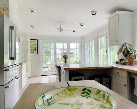 Kitchen dining area leading to patio with grill