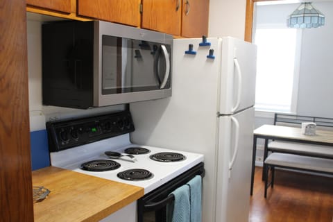 Galley Kitchen with full size fridge, range, microwave and dishwasher