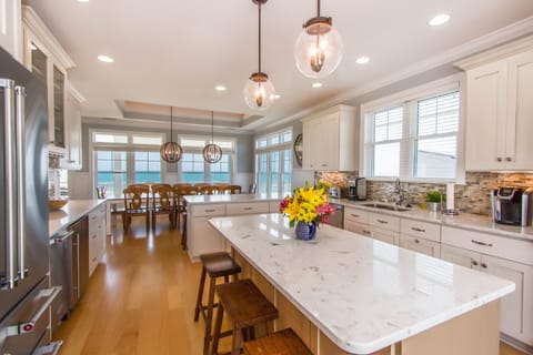 Gourmet kitchen with beverage cooler, ice machine and island with extra seating.