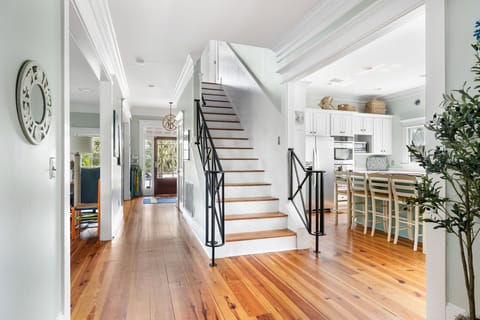 Main hall creates open transit to kitchen, great room, and upstairs.