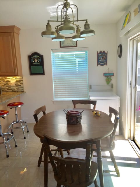 Photo dinning table in kitchen next to sliding doors to deck.