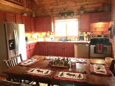 KITCHEN HAS NEW STAINLESS REFRIGERATOR
