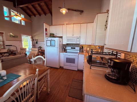 Looking from back door. Kitchen with new (2025) electric range with glass top.