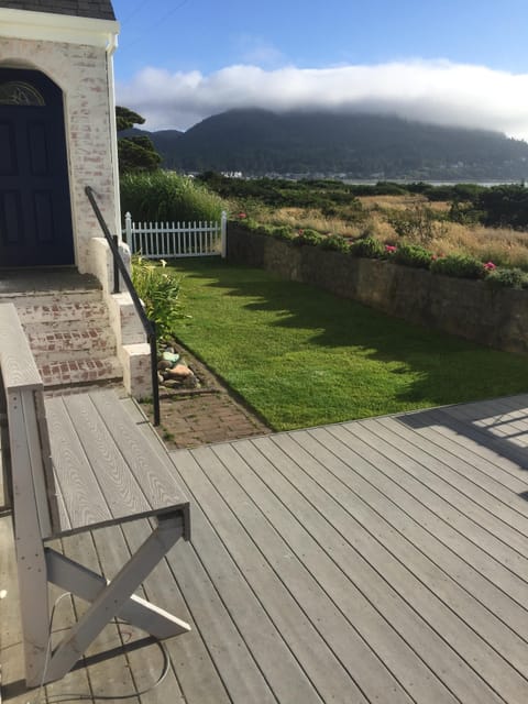 Outside deck with built-in benches, a fenced yard for kids/pets and music too.