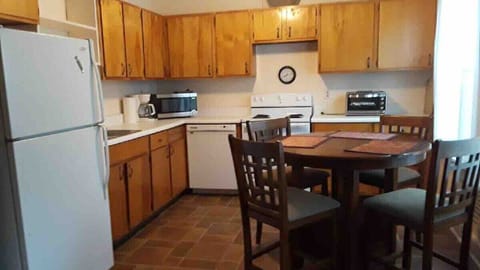 Eat-in kitchen has comfy counter height table and chairs.