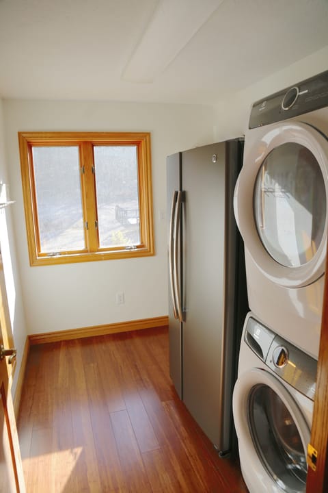 Laundry with Washer and dryer for your use plus a refrigerator by kitchen