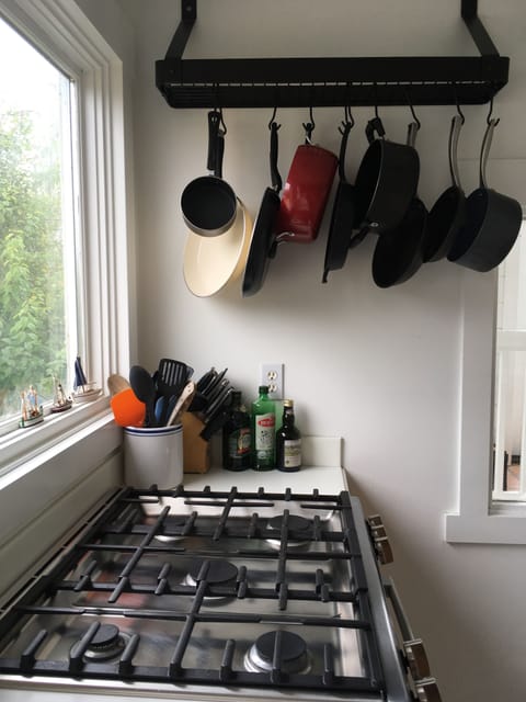 Cast iron & SurLaTable skillets & 4 pots (lids in lower cabinet). Soup pans