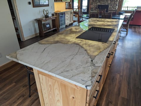 The island counter has under lighting that looks really impressive at night