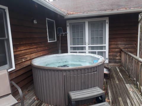 Bring your suits!  Relaxing hot tub on back deck.  Table with 8 chairs