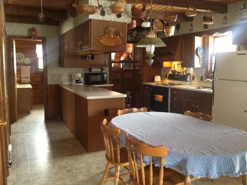 Dining area and kitchen, with bath in background