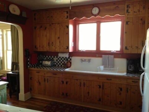 Kitchen with original cabinets and high back sink.