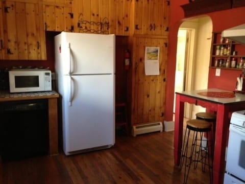 Through kitchen to the third bedroom, downstairs dens, and back patio garden.