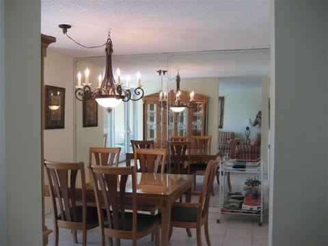 FORMAL DINING ROOM OVERLOOKING BALCONY, POOL AND OCEAN