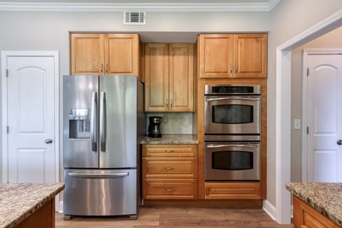 Double ovens; Coffee station beside French door refrigerator. Pantry to the left