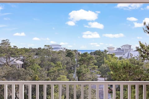 The living room flows out to a large balcony with Gulf of Mexico views.