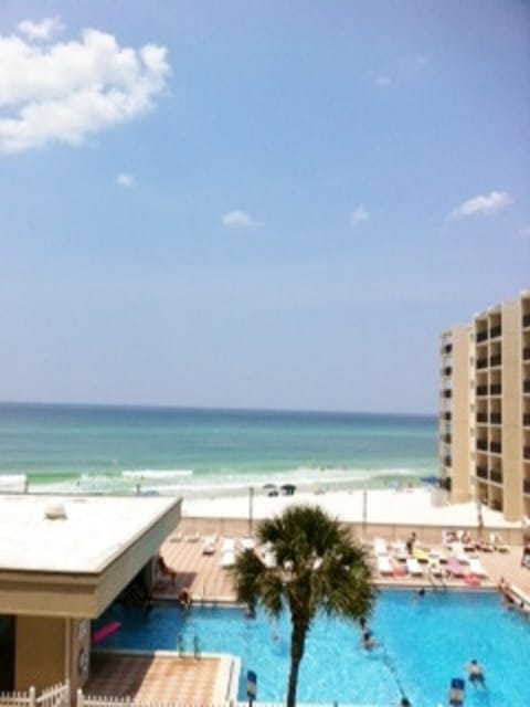 View of large pool and beach from balcony
