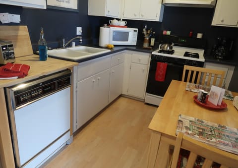 Comfortable eat-in kitchen with dishwasher, microwave and dining table.