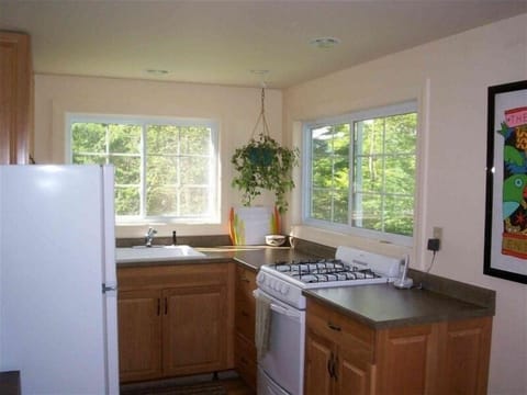 Kitchen with range, refrigerator, microwave