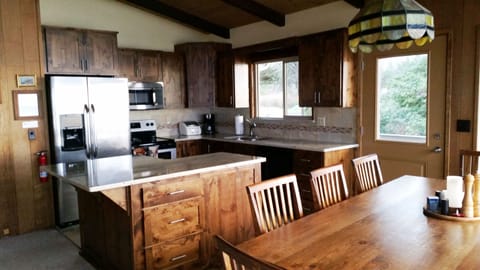 New kitchen with large island and stainless steel appliances.