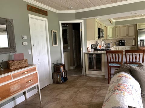 Livingroom view to full bath and utility room with washer/dryer