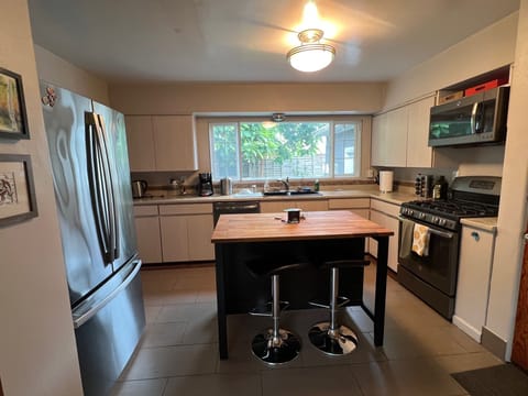 Kitchen with large Island, designer bar stools and open kitchen layout