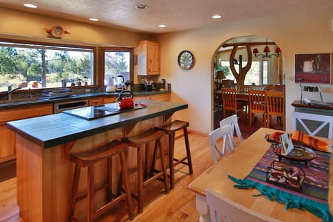 Well equipped kitchen with large windows overlooking the river