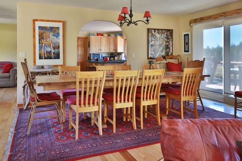 Dining area with direct deck access. Open to living room and into kitchen with additional seating