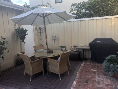 Outside patio with table and chairs and and gas bbq