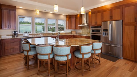 Large gourmet kitchen with expansive island seating