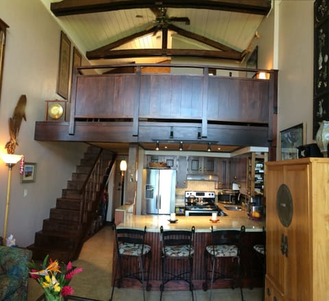 The partially enclosed master bedroom loft is surrounded by beautiful mahogany.