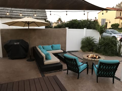 Outdoor fire pit and seating area. + a BBQ