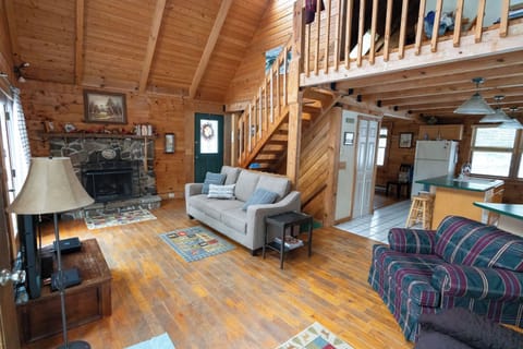 Living room with sofa, chair, love seat, tv, side tables, and fireplace