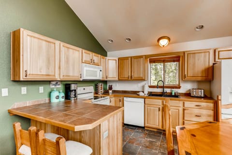 The spacious kitchen has custom tiled counter tops and everything you will need to prepare meals during your stay.