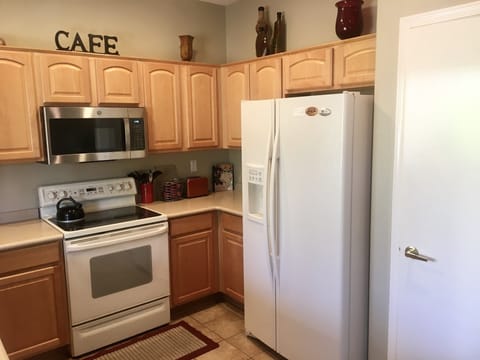 Side-by-side refrigerator with water/ice in door; coffee maker, toaster, pans
