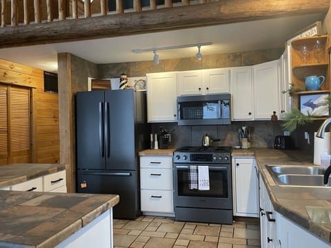 Bosch appliances for cooking and 2 cabinets left empty for storing guests food.